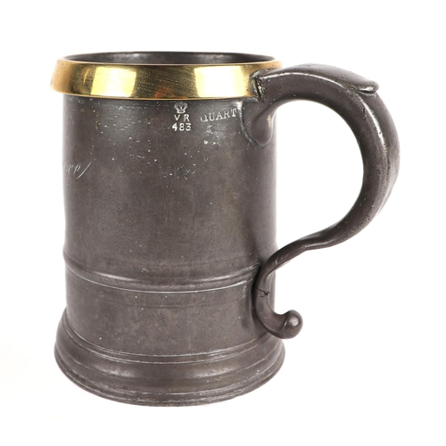 420 - A Victorian quart pewter tankard with copper rim, 'C' scroll handle and inscription; together with a... 