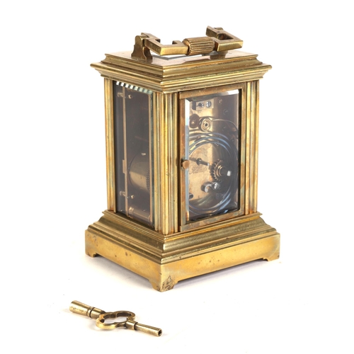 465 - A brass four-pillar carriage clock, the white enamel dial with Roman numerals, 15cms high.