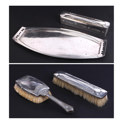 502 - A Secessionist design silver plated four-piece dressing table set to include tray, brushes and trink... 