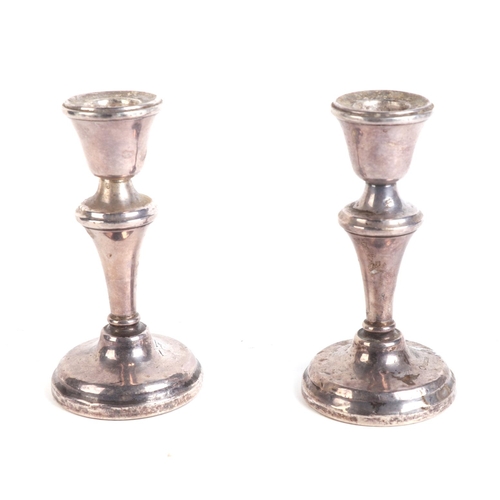 507 - A pair of weighted silver candlesticks, 11cms high.