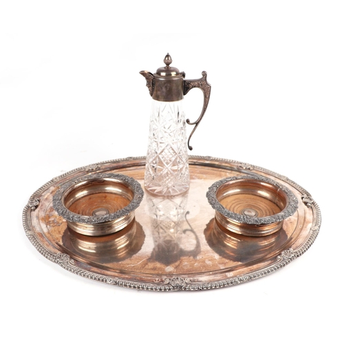 509 - A pair of silver plated wine coasters; together with a silver plate mounted claret jug with Bacchus ... 