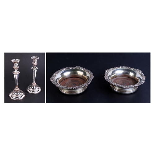 510 - A pair of 19th century silver plated wine coasters; together with a pair of Sheffield plate candlest... 