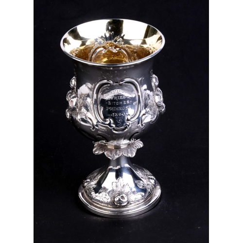 526 - A Victorian silver goblet or chalice decorated flowers, with presentation inscription, London 1874, ... 