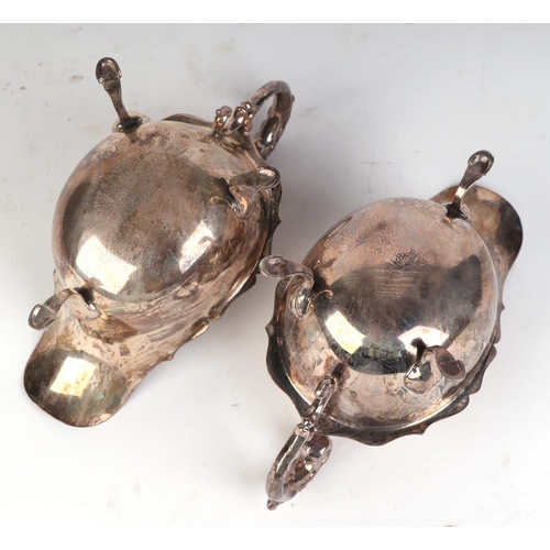 544 - A pair of George V silver sauce boats with scroll handles and shell capped hoof feet, Birmingham 193... 