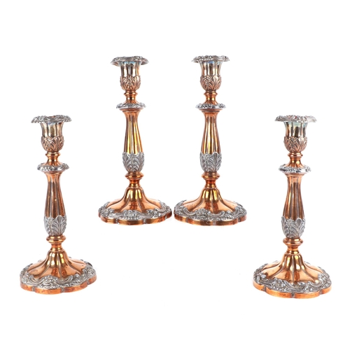 558 - A set of four late 19th century Sheffield plate candlesticks, each with baluster form reeded columns... 