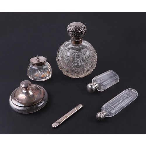 559 - A silver topped cut glass scent bottle of globular form; together with two silver topped scent bottl... 