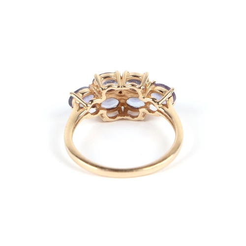 585 - A 14ct gold ring set with six pale purple stones, approx UK size N, 2.8g.