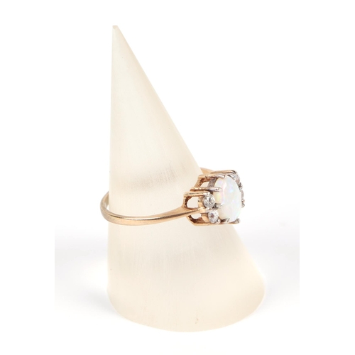 590 - A 9ct gold ring, set with a central opal flanked by four small diamonds, approx UK size L, 1.5g.