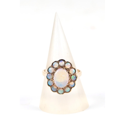 598 - A 9ct gold opal cluster ring, approx UK size M, 3.4g, together with it's original 1991 purchase reci... 