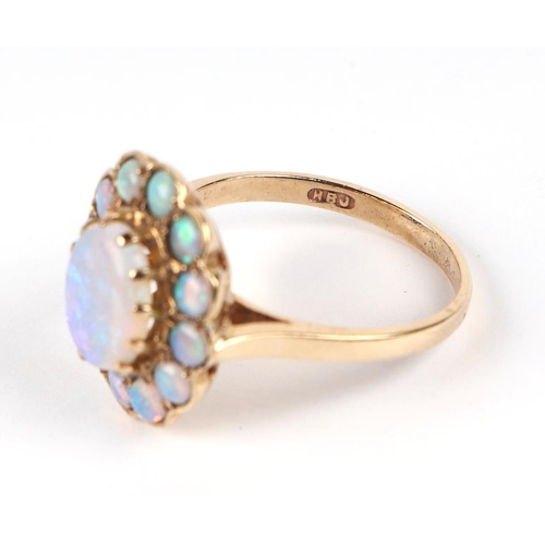 598 - A 9ct gold opal cluster ring, approx UK size M, 3.4g, together with it's original 1991 purchase reci... 