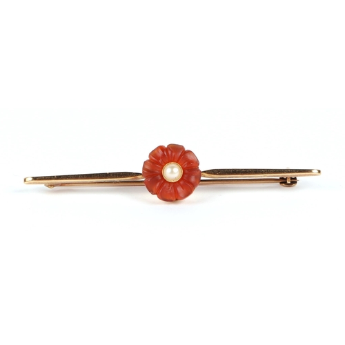 600 - A 15ct bar brooch set with a central flower, pearl and possibly carnelian, 3.6g (boxed).