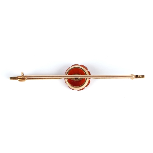 600 - A 15ct bar brooch set with a central flower, pearl and possibly carnelian, 3.6g (boxed).