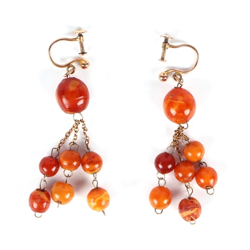 602 - A pair of 9ct gold amber screw back drop earrings.