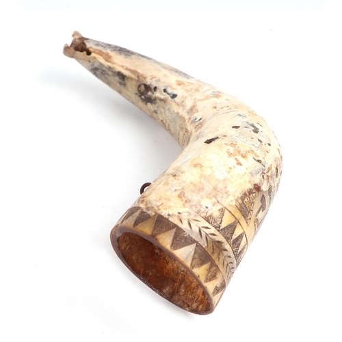 61 - A cow horn powder flask with scrimshaw decoration (a/f), approx 13cms long.