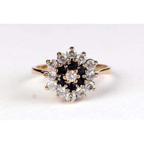 614 - A 9ct gold sapphire and white stone cluster ring, approx UK size O, 3.3g.