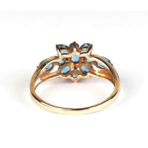 623 - A 9ct gold dress ring set with pale blue stones and diamonds, approx UK size T, 2.9g.