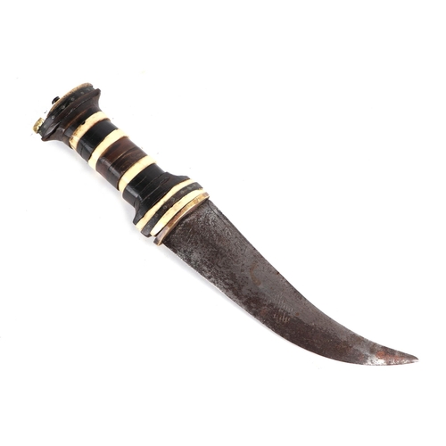 63 - A Middle Eastern dagger, the handle with bone and brass inlaid decoration, the steel blade with an e... 