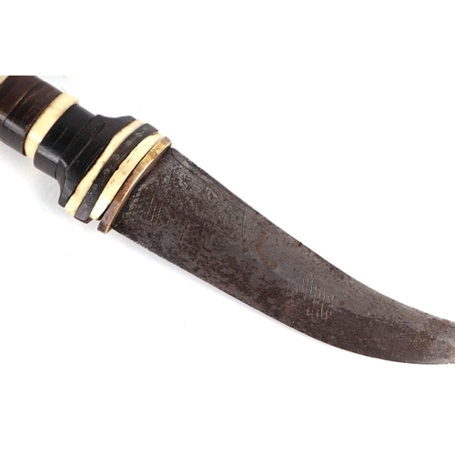 63 - A Middle Eastern dagger, the handle with bone and brass inlaid decoration, the steel blade with an e... 