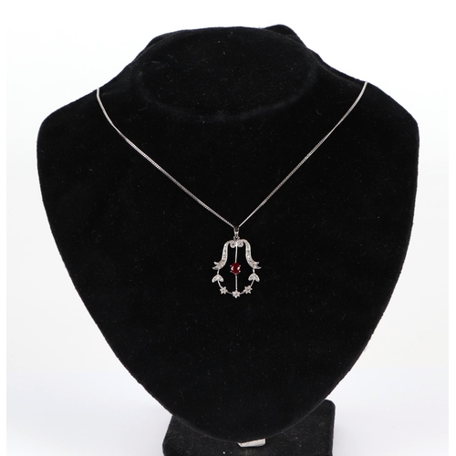 630 - An 18ct white gold diamond and ruby pendant on a fine 18ct white gold chain, 5g.Condition ReportRuby... 