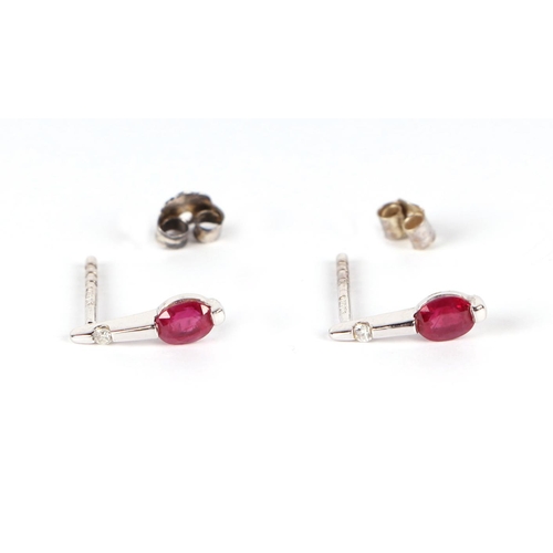 632 - A pair of 18ct gold diamond and ruby earrings.Condition ReportOne butterfly is a 9ct white gold repl... 