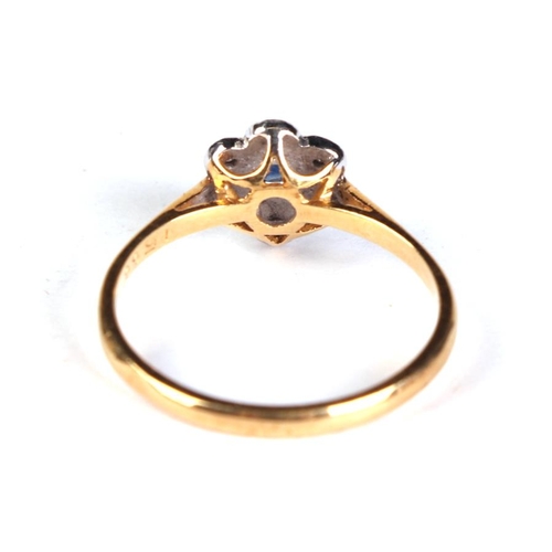 633 - An 18ct gold diamond and sapphire flower ring, approx UK size 'N', 2.2g.