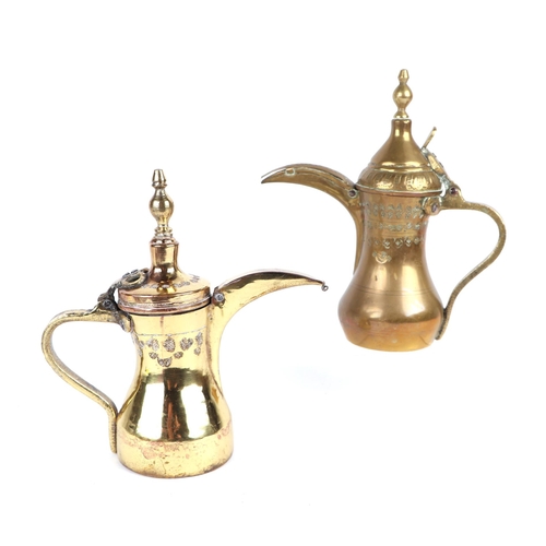 636 - A Turkish / Islamic brass dallah coffee pot, 24cms high; together with another similar, 22cms high (... 