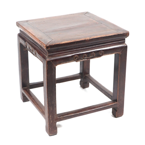 641 - A Chinese hardwood low table with rectangular top, on square legs joined by stretchers, 44cms wide.