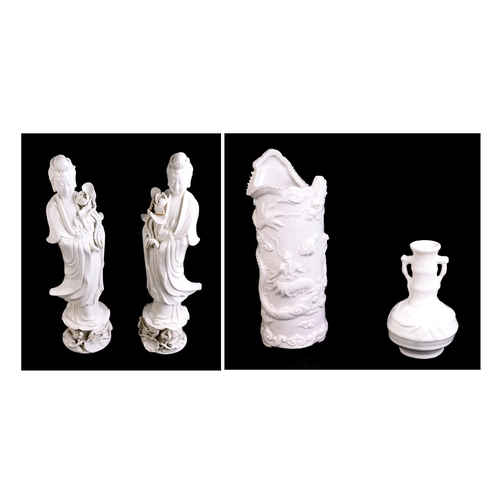 644 - A pair of Chinese blanc de chine figures depicting Guanyin, 36cms high; together with a blanc de chi... 