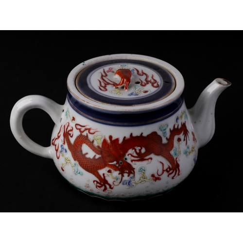 646 - A Chinese porcelain teapot decorated with a pair of five-clawed dragons flying amidst swirling cloud... 