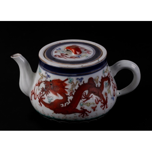 646 - A Chinese porcelain teapot decorated with a pair of five-clawed dragons flying amidst swirling cloud... 