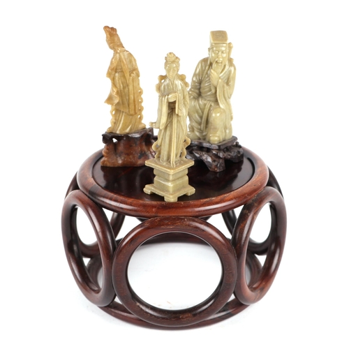 647 - A Chinese hardwood vase stand, 16cms diameter; together with three Chinese soapstone figures, the la... 