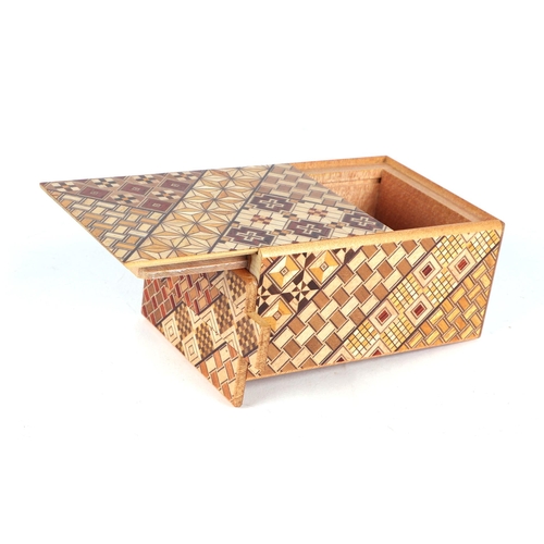 651 - A Japanese Himitsu-Bako wooden puzzle box, 12cms long.