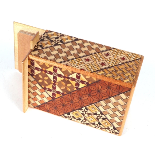 651 - A Japanese Himitsu-Bako wooden puzzle box, 12cms long.