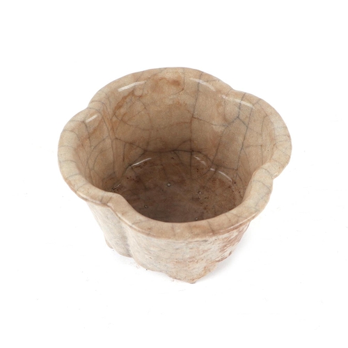 660 - A Chinese pale celadon crackleware lobed planter, 15cms wide.