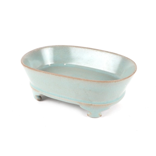 662 - A Chinese celadon glazed brush washer, 17cms wide.