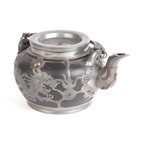 676 - A Chinese pewter overlaid teapot decorated with dragons, four character mark to the underside, 9.5cm... 