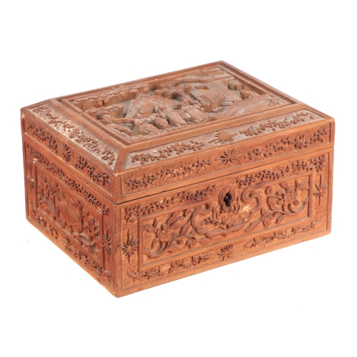 678 - A carved wooden Chinese box decorated with figures in a landscape, 19cms wide.