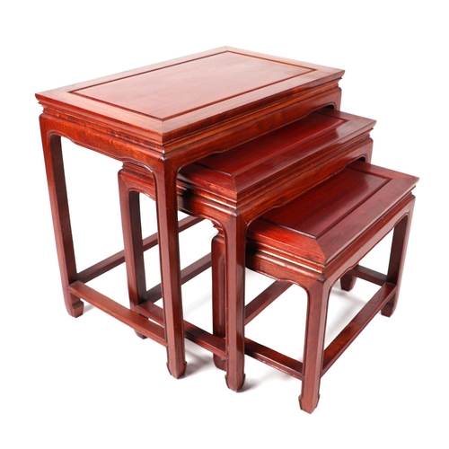 685 - A nest of three Chinese hardwood tables, the largest 60cms wide (3).