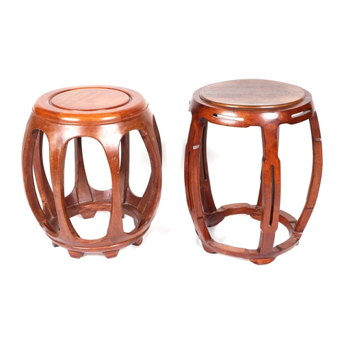 690 - Two Chinese hardwood barrel stools, 45cms high and 48cms high (2).