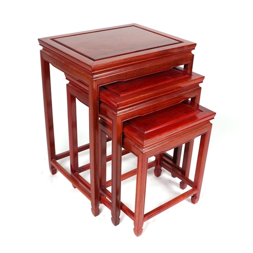 691 - A graduated set of three Chinese hardwood tables, the largest 48cms wide.