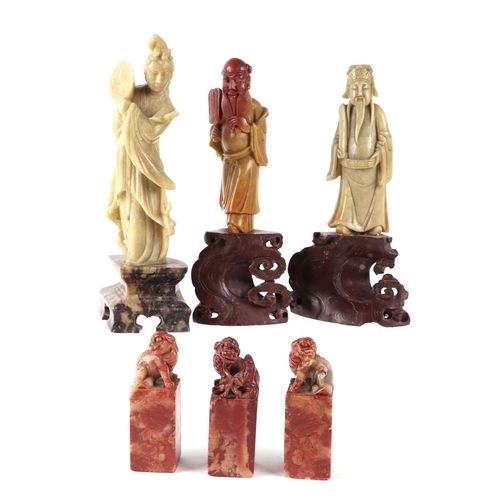 693 - Three Chinese carved soapstone figures, the largest 19cms high; together with three soapstone seals ... 