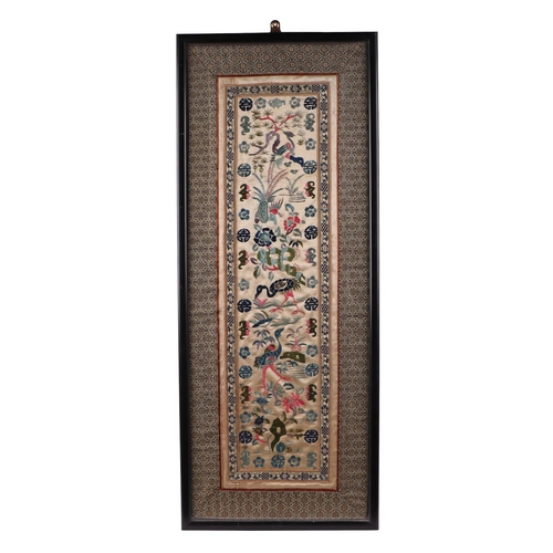 694 - A Chinese silk embroidered panel decorated with birds and flowers, framed & glazed, 15 by 54cms.