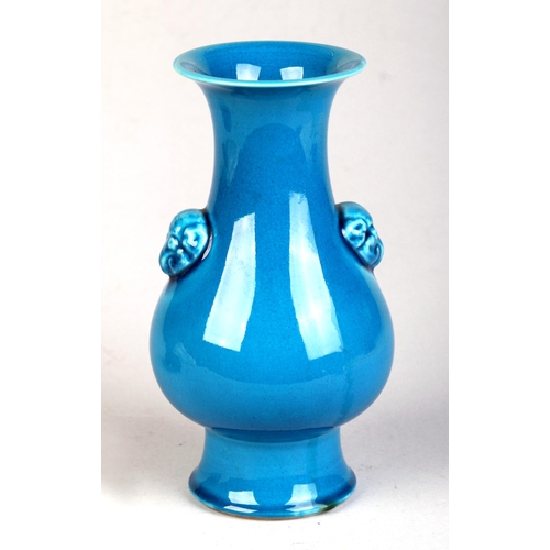 706 - A Chinese blue glazed monochrome vase with black six character mark to the underside, on a hardwood ... 