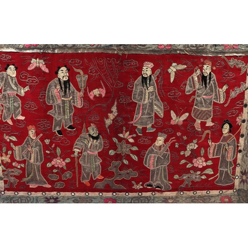 713 - A large Chinese silk embroidered panel decorated with figures in a landscape with bats and butterfli... 