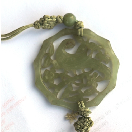 716 - A Chinese pierced jade pendant decorated with a parrot amongst foliage; together with a boxed set of... 