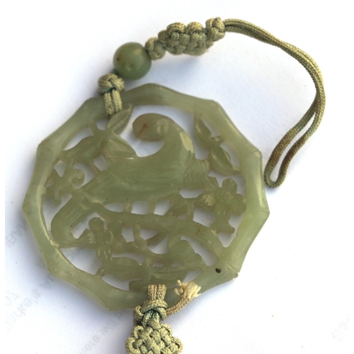 716 - A Chinese pierced jade pendant decorated with a parrot amongst foliage; together with a boxed set of... 