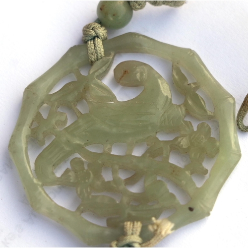 716 - A Chinese pierced jade pendant decorated with a parrot amongst foliage; together with a boxed set of... 