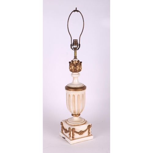 720 - A white and gilt painted table lamp, 45cms high excluding fitment.