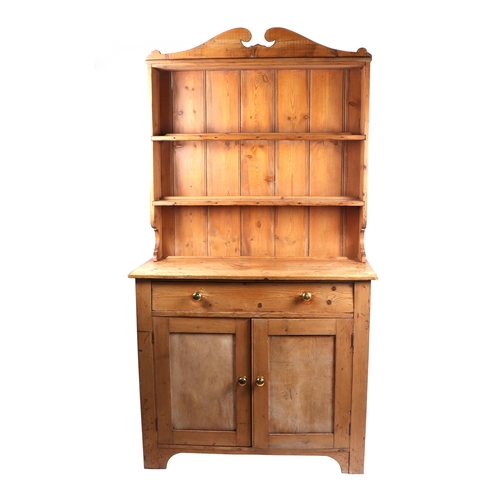 743 - A pine dresser with two-tier plate rack above a cupboard with single frieze drawer, above 2 panelled... 