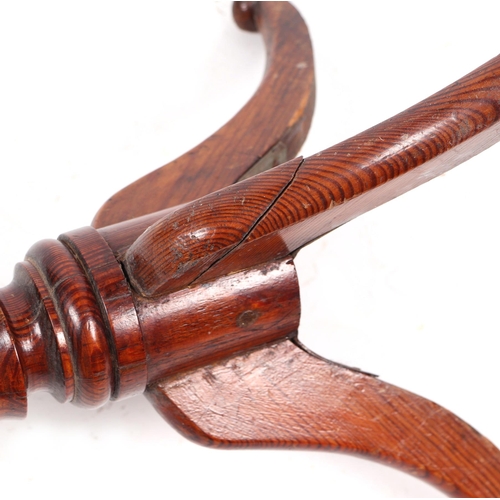 765 - A 19th century occasional table, the circular mahogany top on a turned pitch pine column and tripod ... 